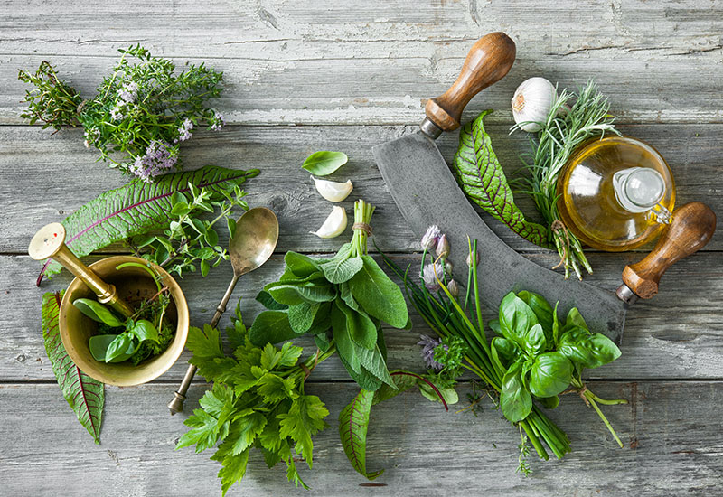 fresh herbs and spices on wooden table